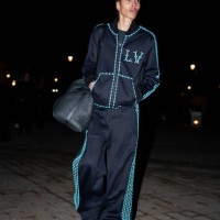 Kai-Isiaiah Jamal wears an all blue sportswear outfit, a sweater, striped track pants / jogger pants, before the Louis Vuitton Menswear Fall-Winter...