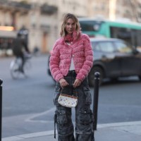 Karin Teigl seen wearing Chanel pink fluffy cardigan jacket, The Attico grey oversized cargo denim jeans, Loewe white tank top, white socks, Chanel...