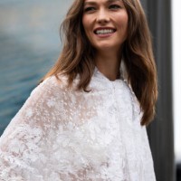 Karlie Kloss wears a white see-trough lace shirt outside Chloé show during Womenswear Spring/Summer 2025 as part of Paris Fashion Week on September...