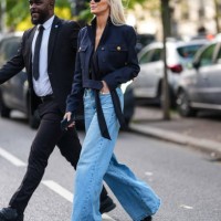 Kate Davidson Hudson wears black sunglasses, dark navy blue cropped jacket, light blue high waisted denim jean pants, black platform leather heels,...