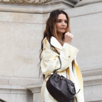 Katie Holmes wears brown top, butter yellow jacket, matching cargo trousers, brown bag, outside Zimmermann, during the Womenswear Fall/Winter...