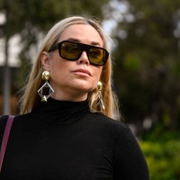 Kelly Hughes is seen wearing a black Nanushka dress, black sunglasses, burgundy bag and silver earrings on December 05, 2024 in Miami, Florida.