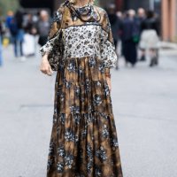 Kelly Rutherford is seen wearing silver maryjane pointy shoes, a brown leather watch, a beige, white and blue floral printed long-sleeved long dress...