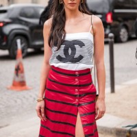 Kelsey Merritt wears black and white striped Chanel top, black and red striped long skirt, outside Chanel, during the Womenswear Fall/Winter...