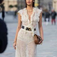 Kelsey Merritt wears white transparent, belted laced dress, brown bag outside Dior during the Womenswear Fall/Winter 2025/2026 as part of Paris...