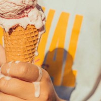 kid holding ice cream cone melting in hot summer. - food stock pictures, royalty-free photos & images