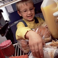 kid in the fridge - junk food stock pictures, royalty-free photos & images