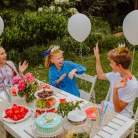 kids are sitting near decorated birthday table in home yard. - garden decoration stock pictures, royalty-free photos & images