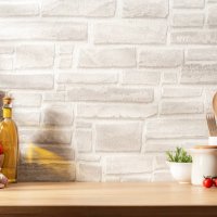 kitchen countertop with utensils, vegetables and spices on brick wall background. copy space available - food stock pictures, royalty-free photos & images