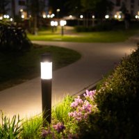 lamps shining on the sidewalk in an elegant grassy courtyard at night - garden decoration stock pictures, royalty-free photos & images