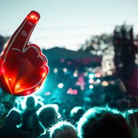 large foam hand over crowd of people having fun during music festival - concert stock pictures, royalty-free photos & images