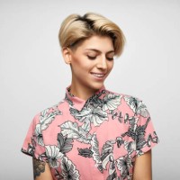 latin american woman in shirt against gray background - fashion stock pictures, royalty-free photos & images