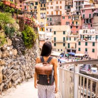 latin woman visiting beautiful town in cinque terre coast, italy - travel stock pictures, royalty-free photos & images