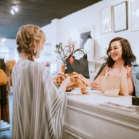 latina boutique store owner at checkout counter - fashion stock pictures, royalty-free photos & images