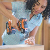 latino female using a cordless drill to drill screw - home decoration stock pictures, royalty-free photos & images