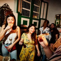 laughing female friends enjoying food during party in night club - fashion stock pictures, royalty-free photos & images