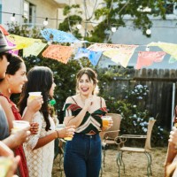laughing group of friends sharing drinks during backyard barbecue on summer afternoon - garden decoration stock pictures, royalty-free photos & images
