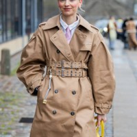 Laura Schulte wears brown belted trench coat, yellow Balenciaga bag outside Munthe during the Copenhagen Fashion Week Autumn/Winter 2025 on January...