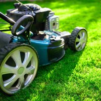 lawn mower on green grass in a sunny day. - garden decoration stock pictures, royalty-free photos & images