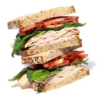 layered turkey sandwich with lettuce and tomato - food stock pictures, royalty-free photos & images