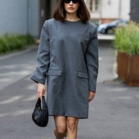 Lea Naumann wears grey oversized dress, black Miu Miu bag outside Gestuz during day four of the Copenhagen Fashion Week SS25 on August 08, 2024 in...