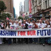 Led by US fashion designer Tory Burch and US fashion designer Michael Kors , attendees march in the "Fashion For Our Future" rally to raise awareness...