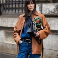 Leia Sfez wears black bag, brown jacket, denim shirt, belt, jeans outside Hermes during the Womenswear Fall/Winter 2024/2025 as part of Paris Fashion...