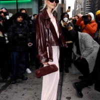 Leonie Hanne wearing a leather jacked long pink dress and bag arrives at the LaPointe show during New York Fashion Week on February 09, 2025 in New...