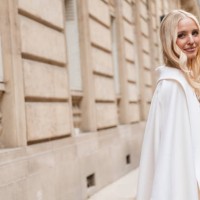 Leonie Hanne wears cream coat, outside Valentino, during the Womenswear Fall/Winter 2024/2025 as part of Paris Fashion Week on March 03, 2024 in...