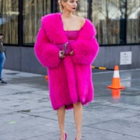 Leonie Hanne wears pink coat, dress, bag, heels outside Michael Kors New York Fashion Week during on February 15, 2023 in New York City.