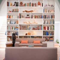light-filled living room with tall bookshelves - home decoration stock pictures, royalty-free photos & images