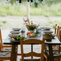 light bulbs hanging over dining table with chairs at patio in backyard - garden decoration stock pictures, royalty-free photos & images