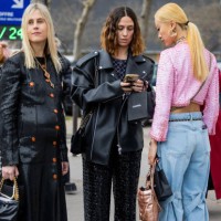 Linda Tol wears sequined black button up dress & Erika Boldrin wears black pants, leather jacket & Niki Wu Jie wears pink jacket, denim jeans outside...