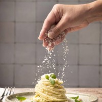 linguine pasta on plate with pesto and basil human hand - food stock pictures, royalty-free photos & images