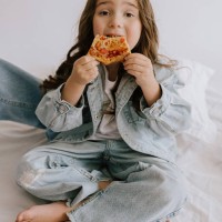 little 5 year old girl eating pizza margherita having lunch - junk food stock pictures, royalty-free photos & images