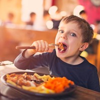 little boy enjoying dinner at the restaurant - food stock pictures, royalty-free photos & images