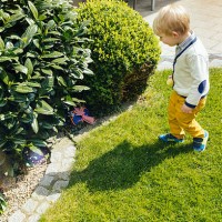 little boy finding an easter surprise in the garden - garden decoration stock pictures, royalty-free photos & images