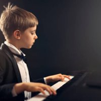 little boy virtuoso performing piano concerto - concert stock pictures, royalty-free photos & images
