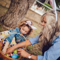 little girl and grandmother during easter egg hunt in park - garden decoration stock pictures, royalty-free photos & images