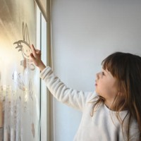 little girl drawing on a fog window. - home decoration stock pictures, royalty-free photos & images