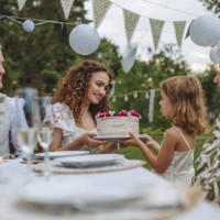 little girl handing the bride a wedding cake. - garden decoration stock pictures, royalty-free photos & images