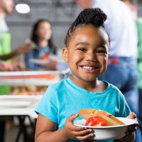 little girl holding bowl at soup kitchen or food bank - food stock pictures, royalty-free photos & images