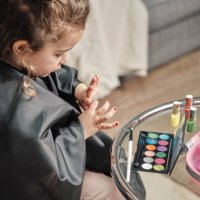 little girl is removing the paint from her nails - nails art photos et images de collection