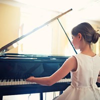 little girl playing on grand piano - concert stock pictures, royalty-free photos & images