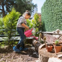 little girl watering fresh planted cactus flowers - garden decoration stock pictures, royalty-free photos & images