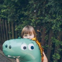 little girl with large balloon in the yard - garden decoration stock pictures, royalty-free photos & images