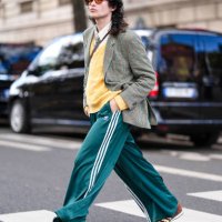 Loic Hornekcer wears dark brown sunglasses, white buttoned up long sleeve shirt, light yellow knit sweater light green tie, light green pattern...