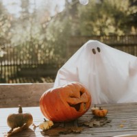 lonely ghost sitting on the porch during halloween - home decoration stock pictures, royalty-free photos & images