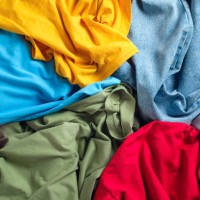 lots of bright dirty colorful scattered clothes, abstract background. the concept of homework, lack of time for household chores. - fashion stock pictures, royalty-free photos & images