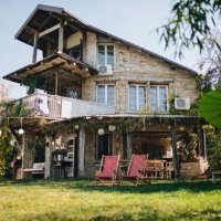 lovely stone house with a big front yard and a porch swing - garden decoration stock pictures, royalty-free photos & images